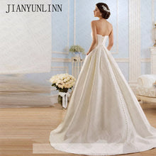 Load image into Gallery viewer, Modern strapless satin box pleated ball gown with pockets.