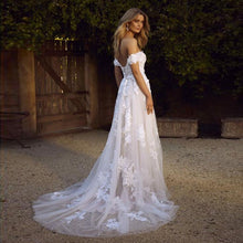 Load image into Gallery viewer, Off the shoulder lace appliqued tulle wedding gown.