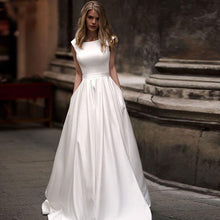 Load image into Gallery viewer, Eggshell white satin A-line ball gown with 1/2 capped sleeves and small side pockets - Oh MY LLC Private Label AEDVEG6