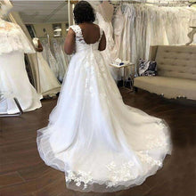 Load image into Gallery viewer, Stunning tulle wedding gown with lace appliques, capped sleeves and chapel length train