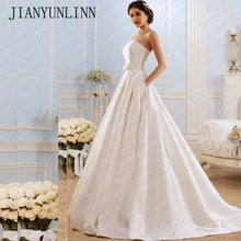 Load image into Gallery viewer, Modern strapless satin box pleated ball gown with pockets.
