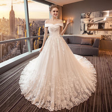 Load image into Gallery viewer, Stunning off the shoulder boat neck lace applique ball gown.
