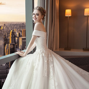 Stunning off the shoulder boat neck lace applique ball gown.