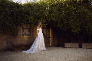 Off the shoulder lace appliqued tulle wedding gown.