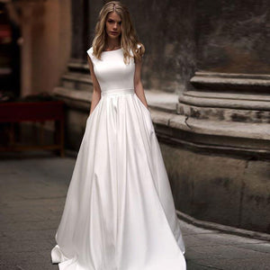 Eggshell white satin A-line ball gown with 1/2 capped sleeves and small side pockets