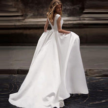 Load image into Gallery viewer, Eggshell white satin A-line ball gown with 1/2 capped sleeves and small side pockets

